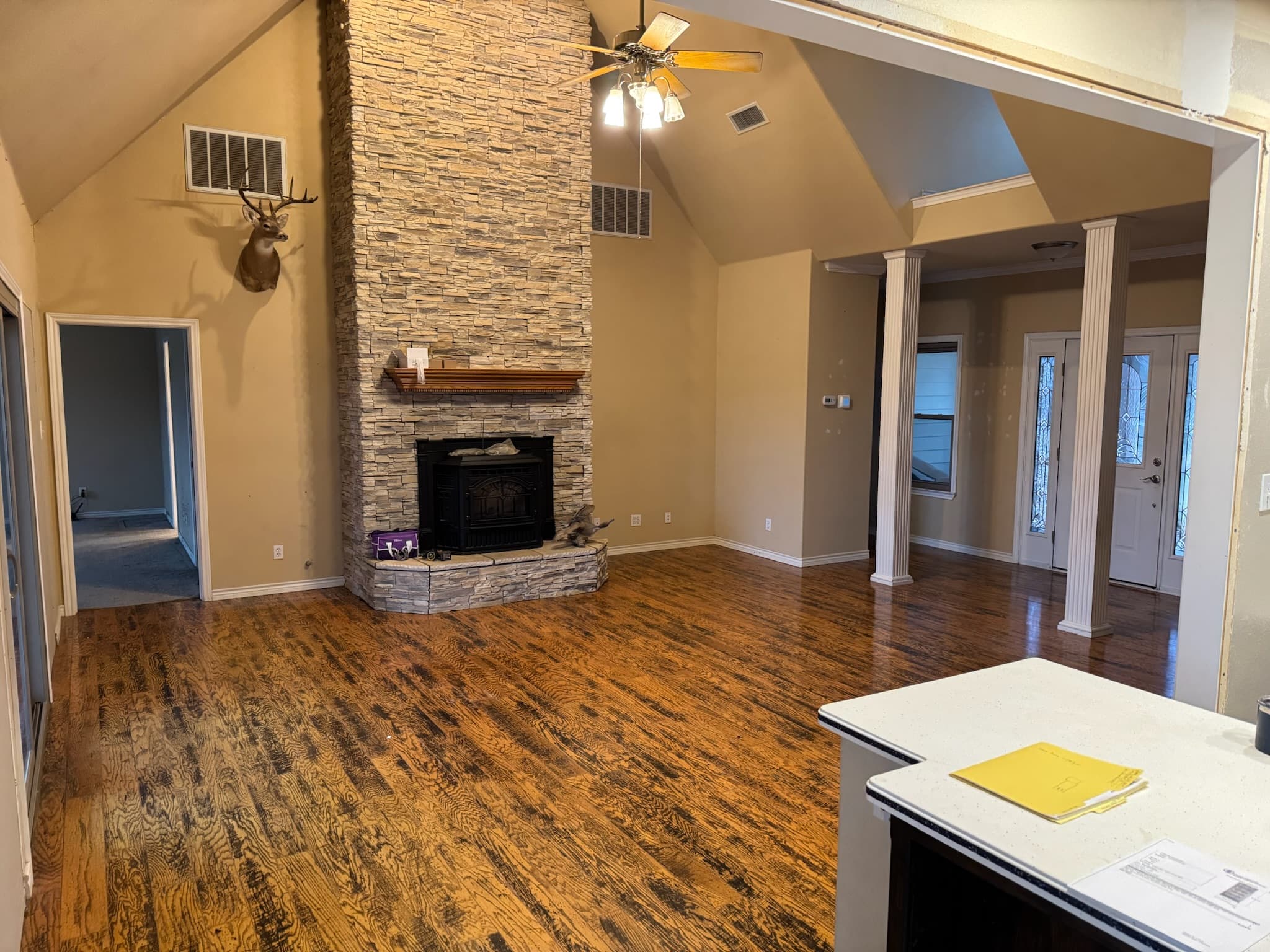 Hartless great room before — dated finishes and red oak floors
