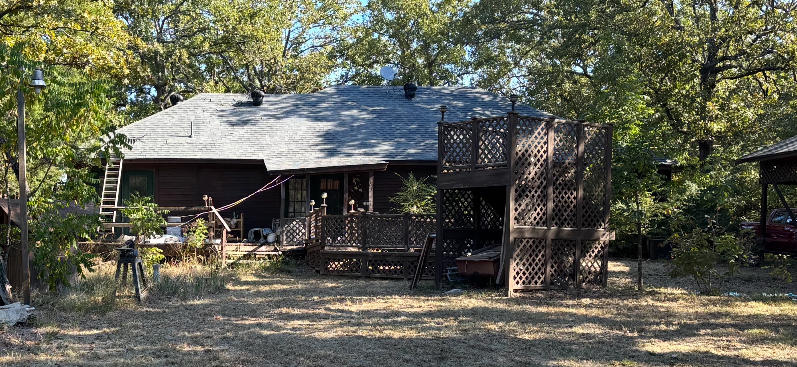 Timpanaro home before remodel — dated dark wood siding
